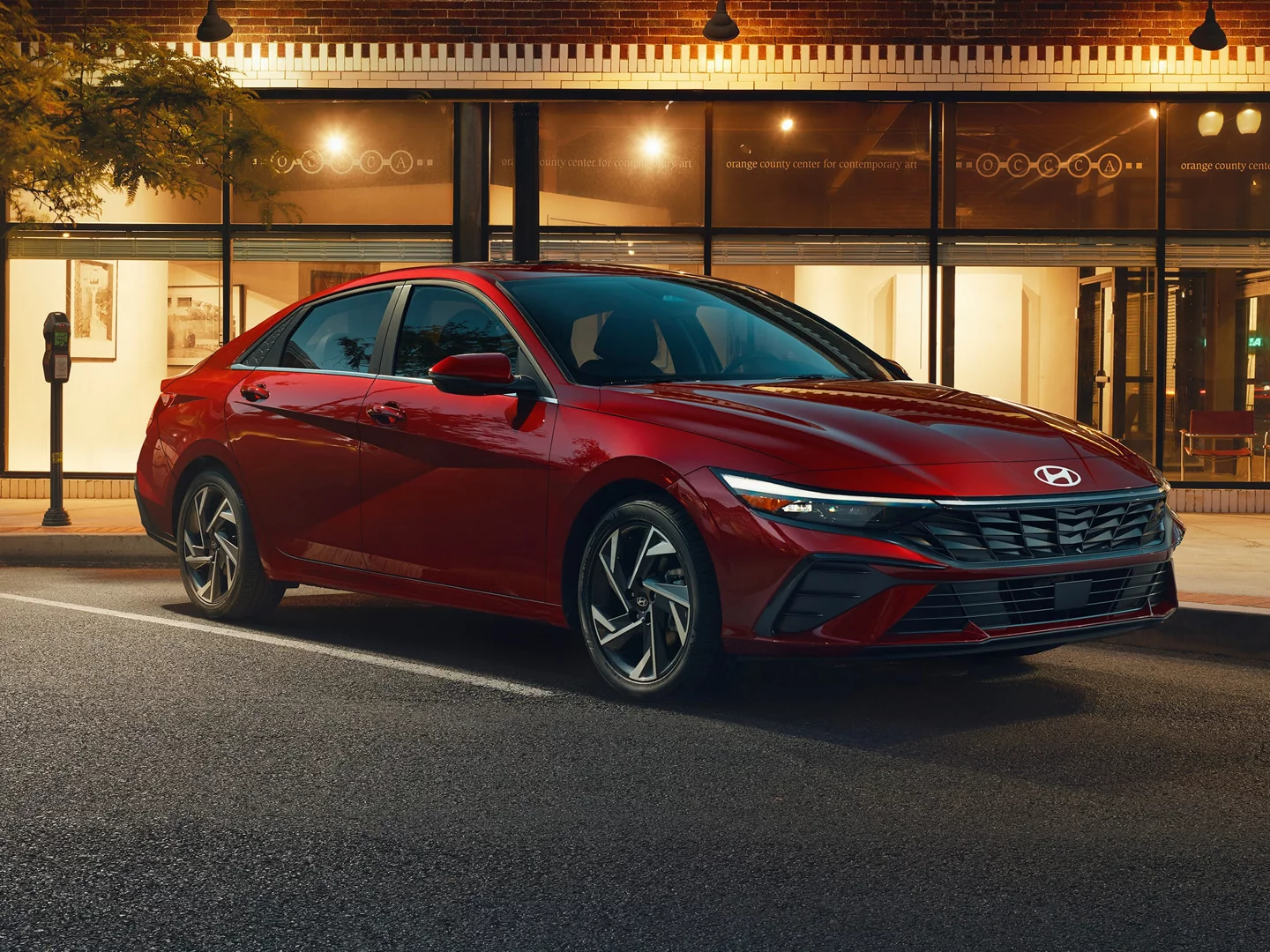 Hyundai sedan driving along a tree-lined road