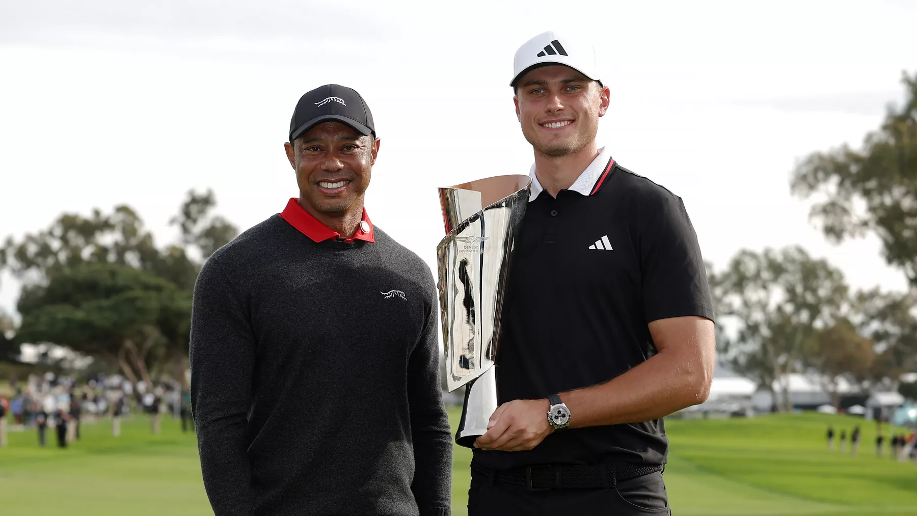 2025 Genesis Invitational Winner Ludvig Aberg pictured with Tiger Woods and the winner's trophy