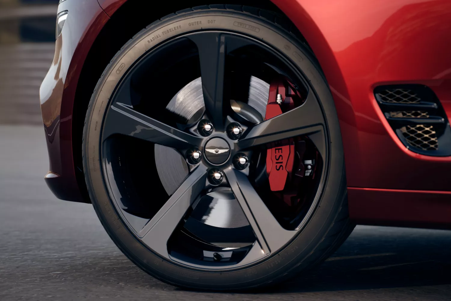 "Design Details" component with close up of wheel detail on Genesis G70 in Cavendish Red