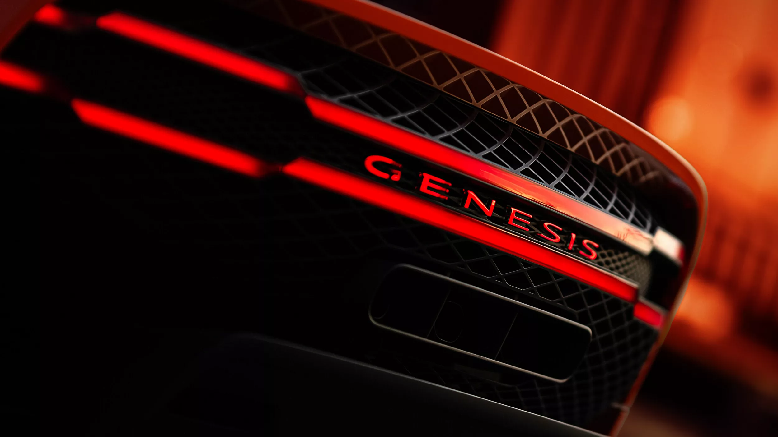 Rear close-up of illuminated Genesis badging and tail lights on Genesis GT Magma concept vehicle