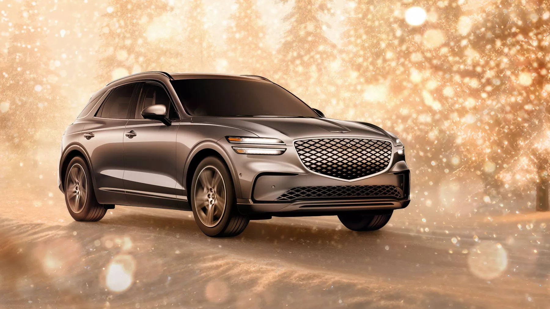 3/4 front passenger side view of Electrified Genesis GV70 parked in snowy gold sparkling environment