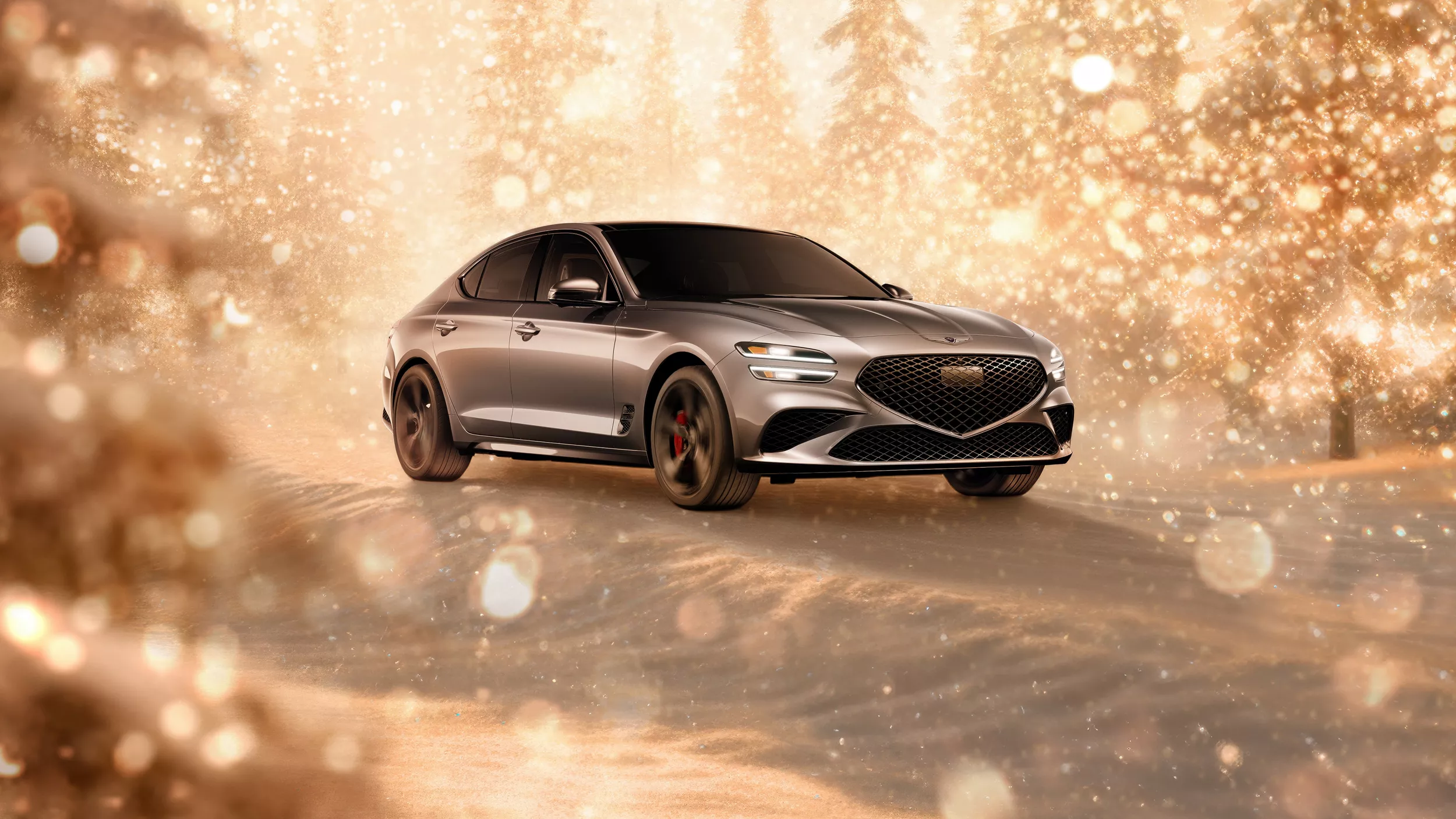 3/4 front passenger side view of gray 2026 Genesis G70 parked in snowy, gold sparkling environment