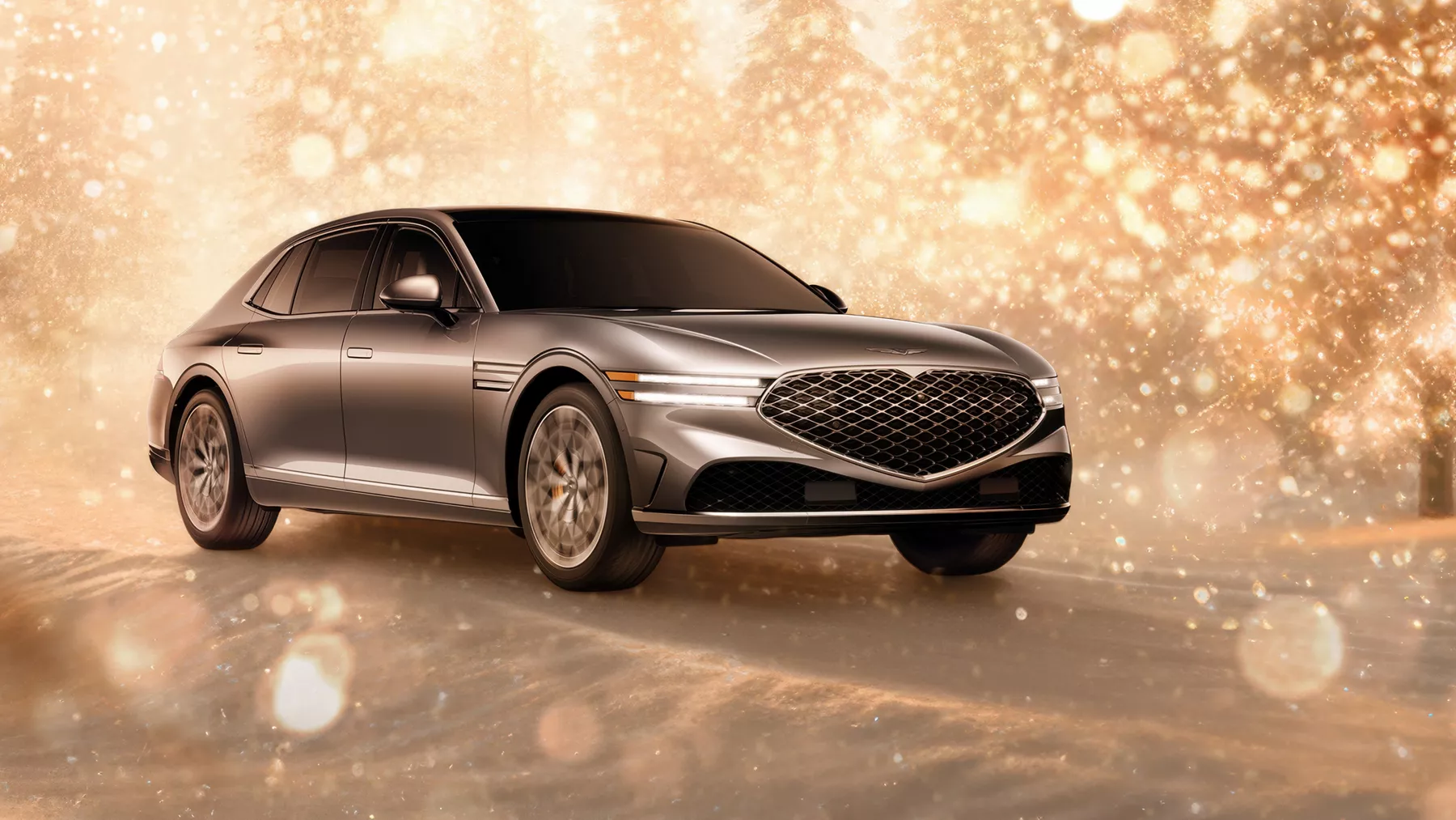 3/4 front passenger side view of gray 2025 Genesis G90 parked in snowy, gold sparkling environment
