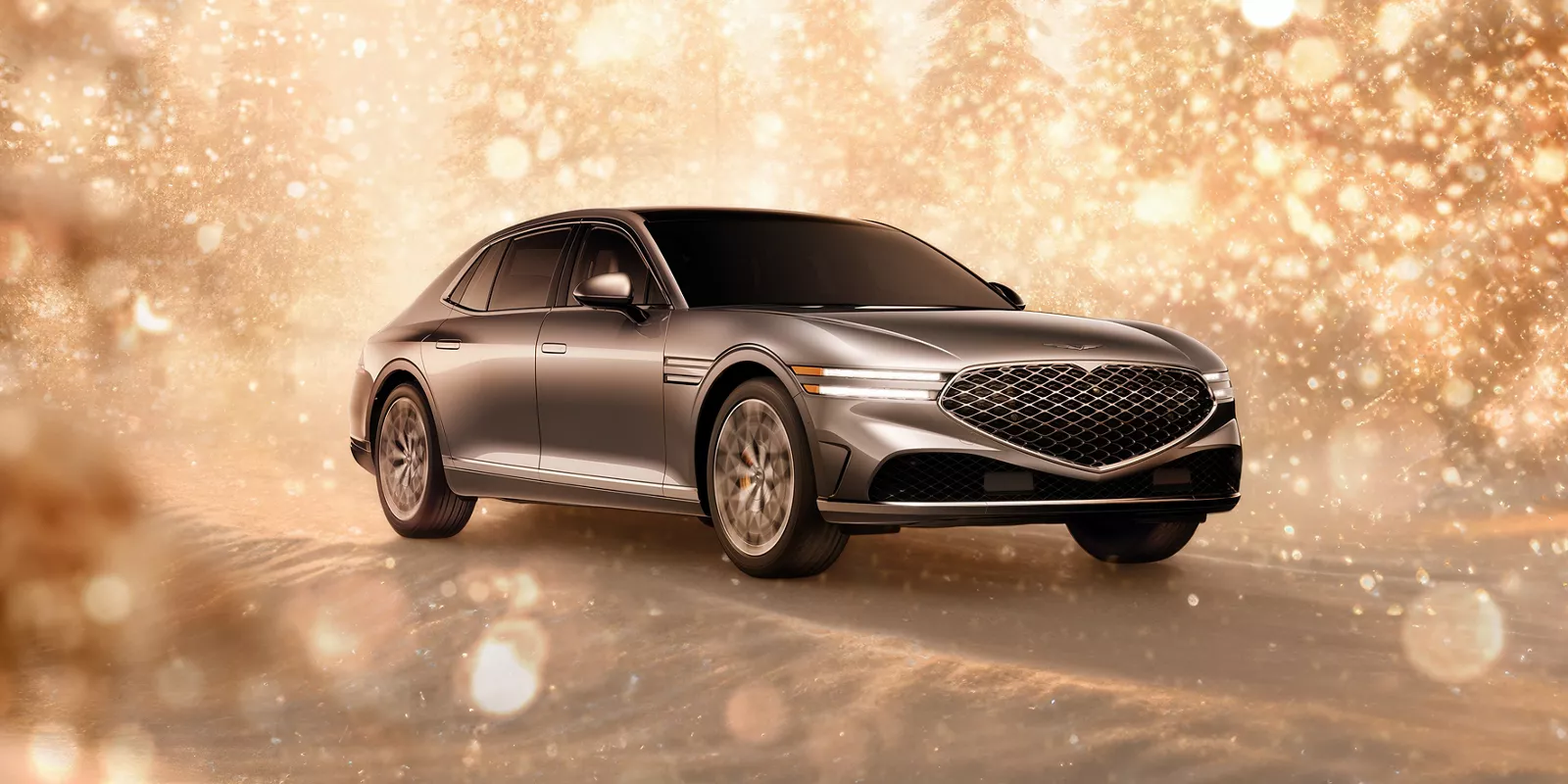 3/4 front passenger side view of gray 2025 Genesis G90 parked in snowy, gold sparkling environment