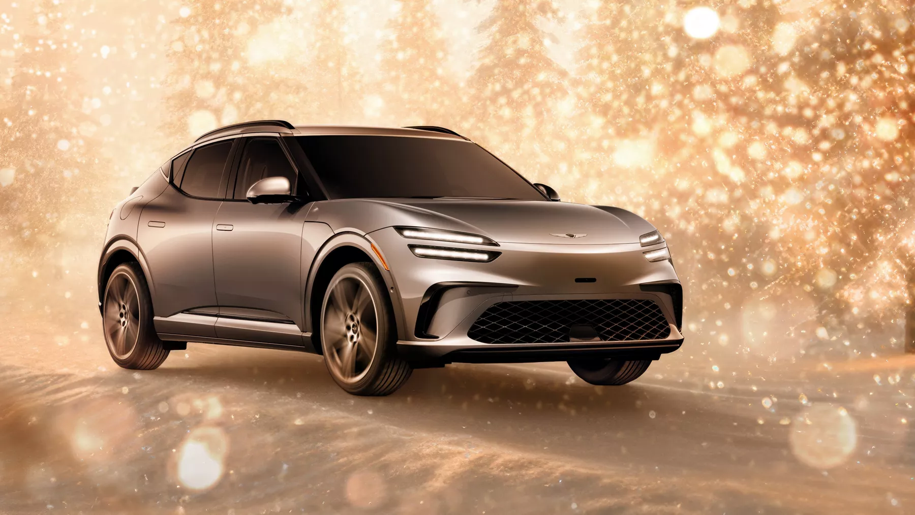 3/4 front passenger side view of gray 2026 Genesis GV60 parked in snowy, gold sparkling environment