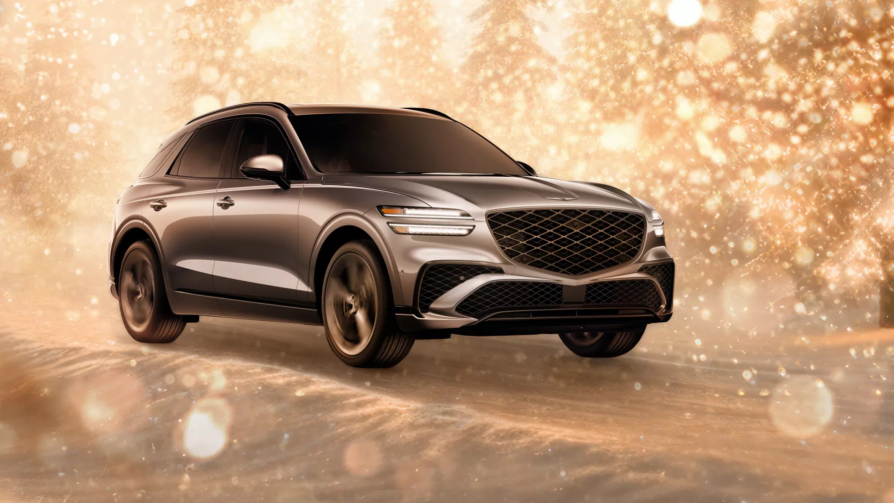 3/4 front passenger side view of gray 2026 Genesis GV70 parked in snowy, gold sparkling environment