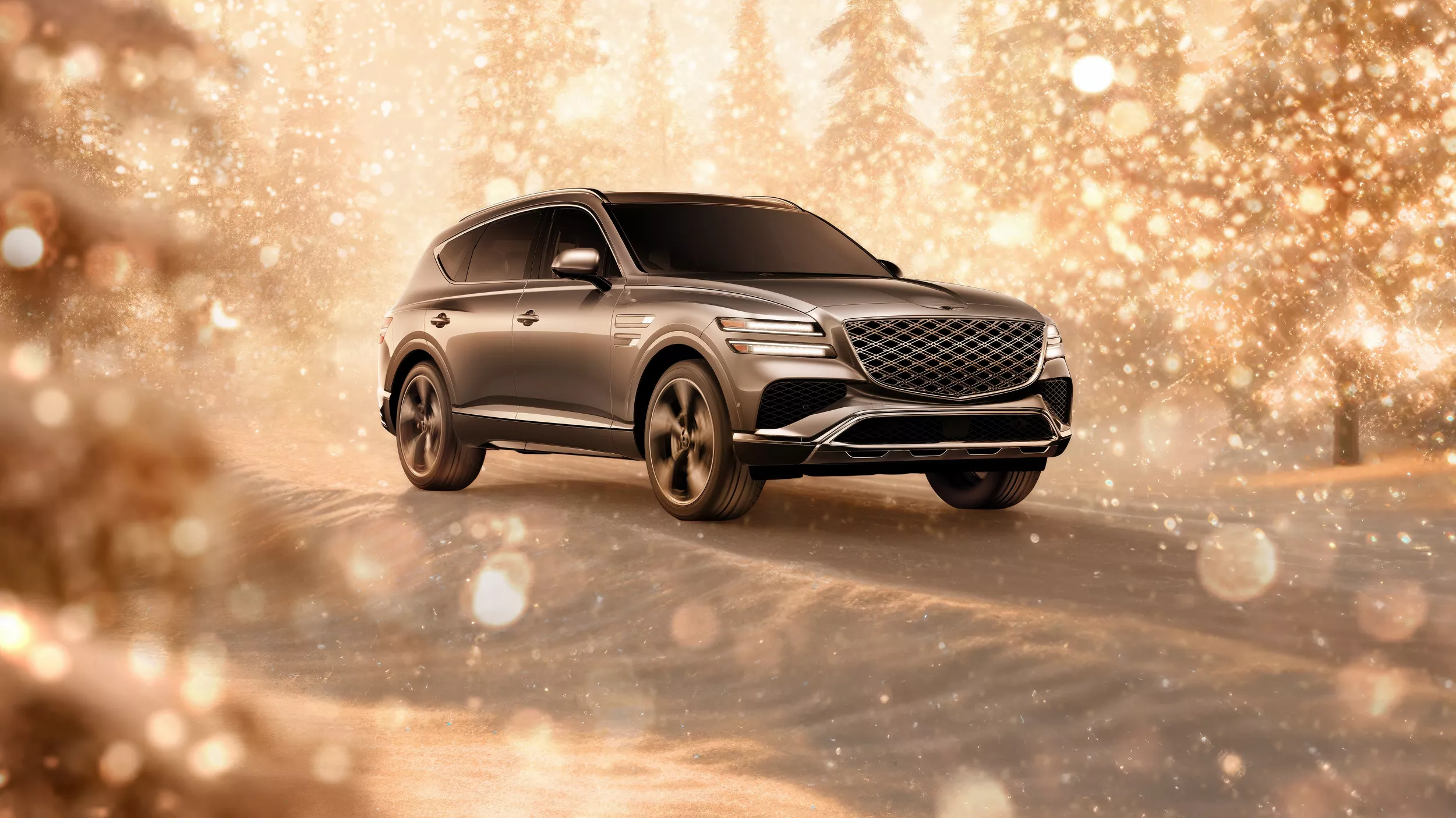 3/4 front passenger side view of gray 2026 Genesis GV80 parked in snowy, gold sparkling environment