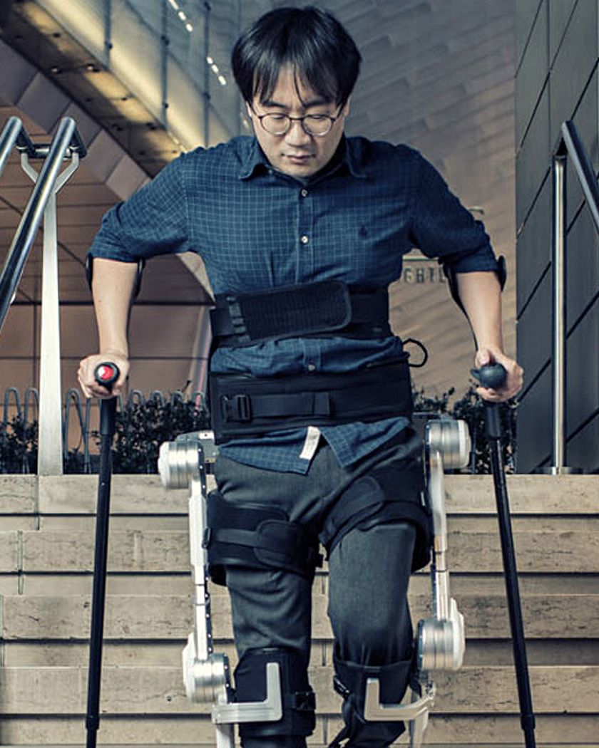 Hyundai engineer wearing Hyundai’s Exoskeleton walks down the stairs in Hyundai Cradle plant