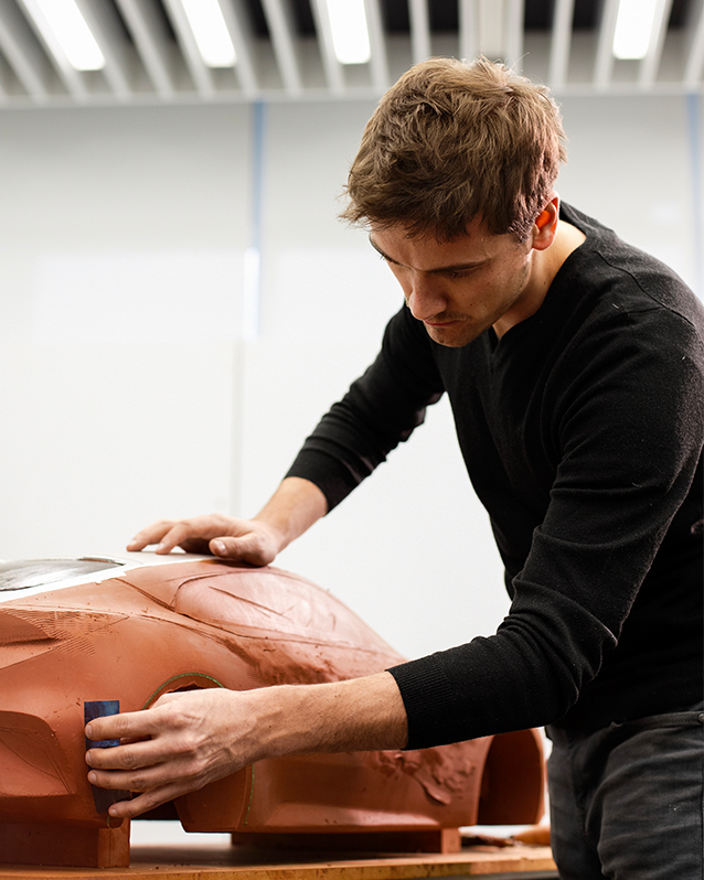 Hyundai employee carves a small car prototype on clay in Hyundai’s plant in Irvine California