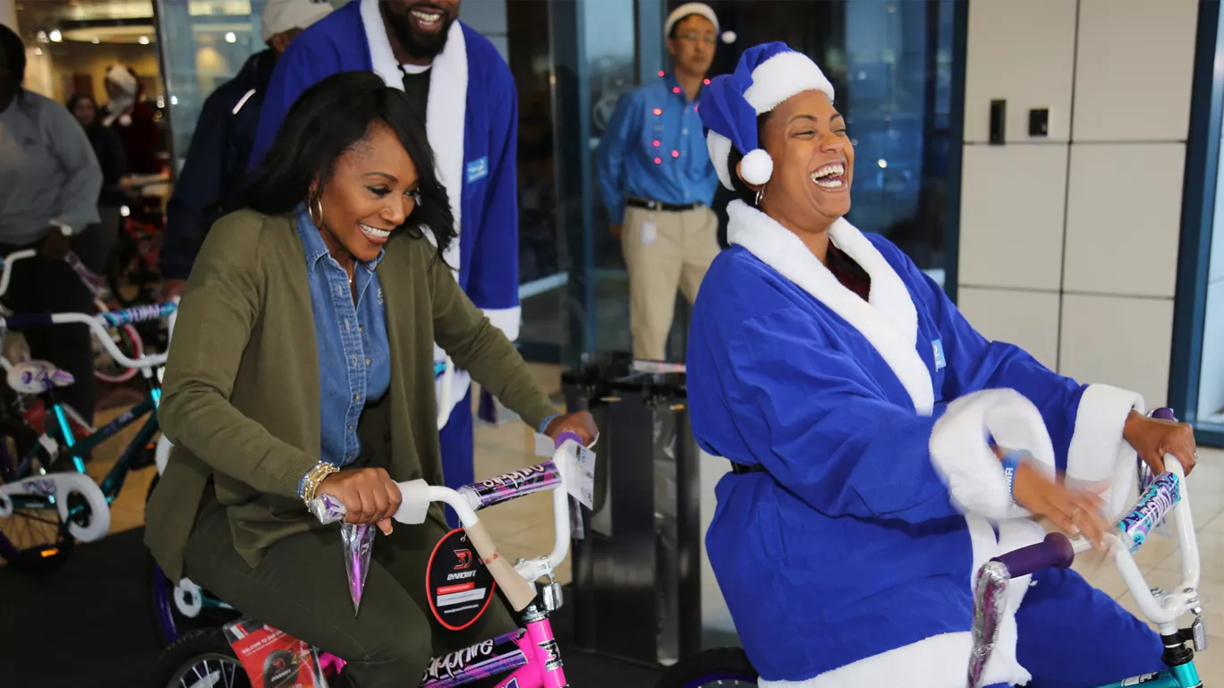 Hyundai employees ride bikes during Toys for Tots event.