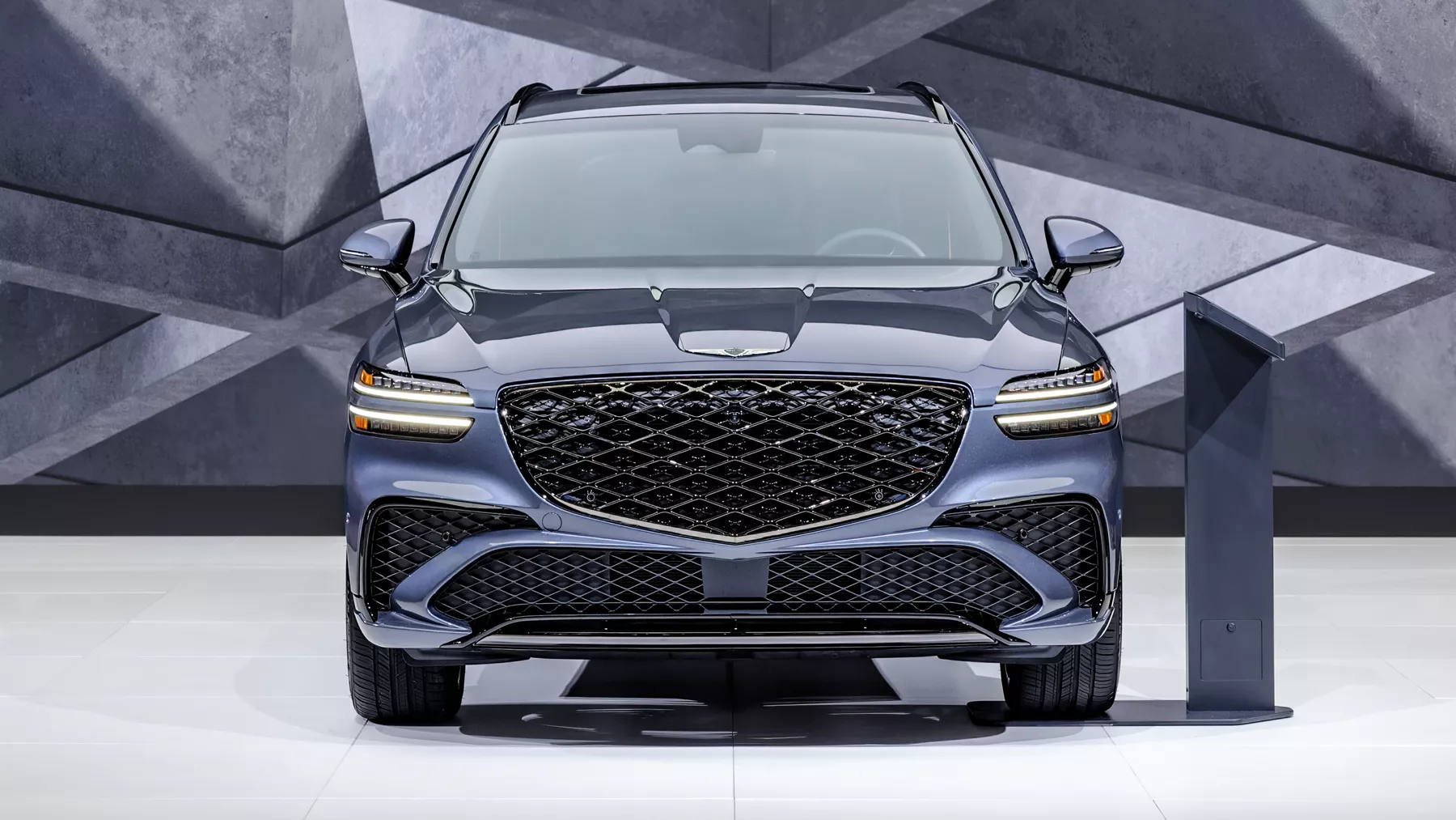 front of blue Genesis concept vehicle on display at Los Angeles Auto Show