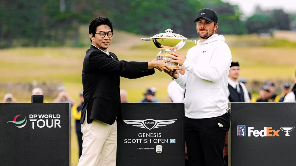 2025 Genesis Scottish Open winner, Chris Gotterup holding a trophy on the green