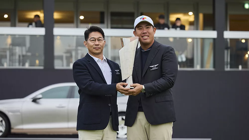 Two men holding a trophy during the Genesis Golf Championship in Seoul, South Korea