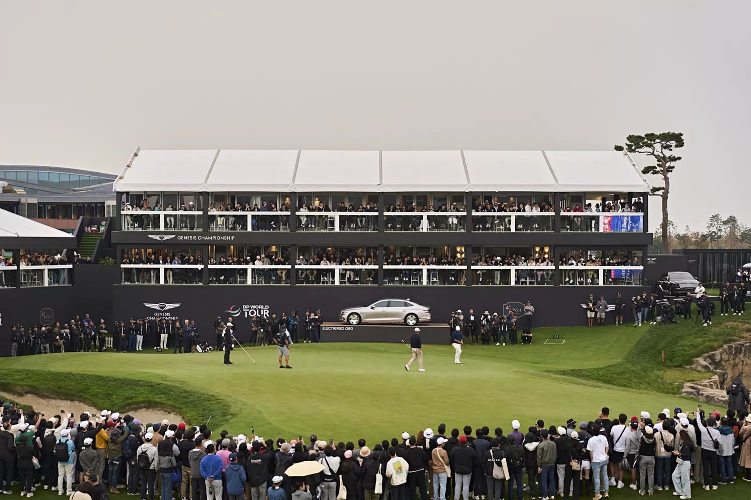 Action shot of play at Genesis Golf Championship in Seoul with Genesis sedan on display in background