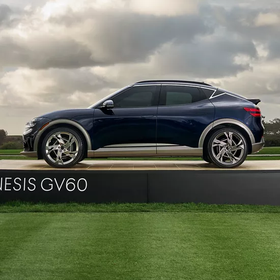 Driver profile view of Genesis GV60 on display on the green at the Genesis Invitational