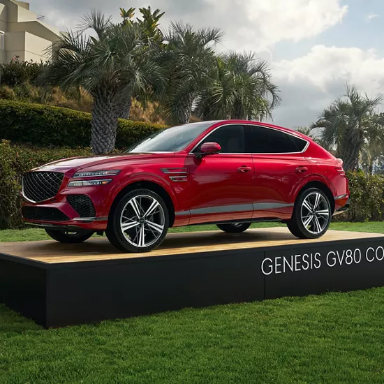 Genesis GV80 Coupe in Mauna Red on display at the entrance of the Genesis Invitational