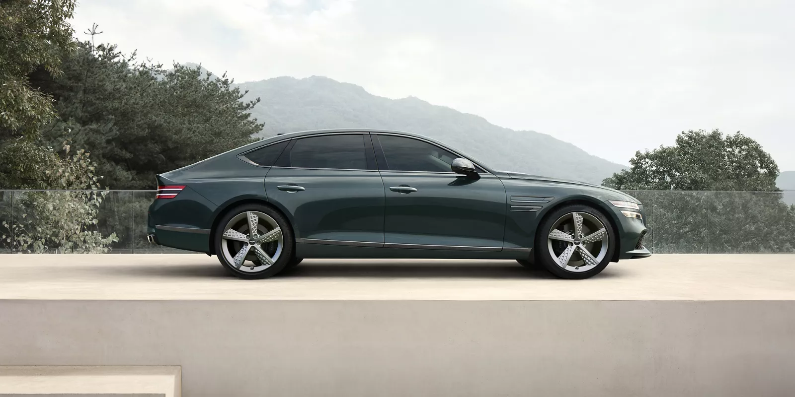 Genesis G80 side view with mountain background