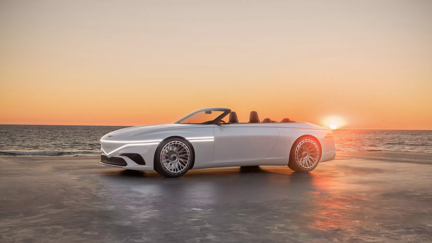 X Convertible Concept in front of a dramatic ocean sunset. 