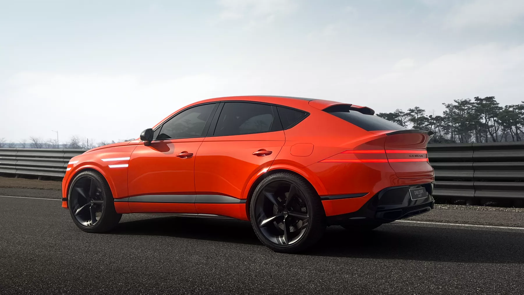 Side profile of the GV80 Coupe Concept on a racetrack.