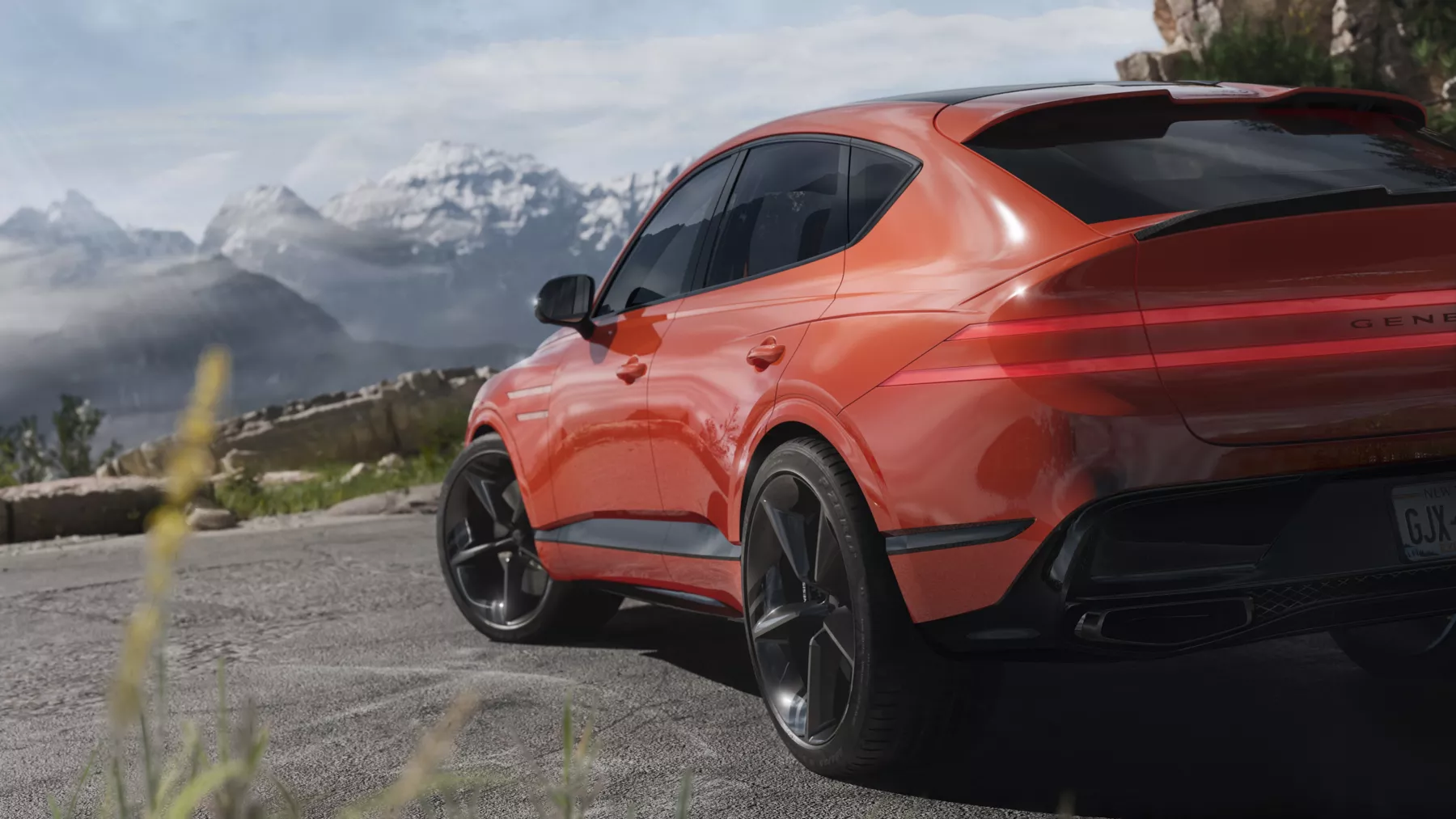 Side profile of the GV80 Coupe Concept positioned against a mountain landscape.