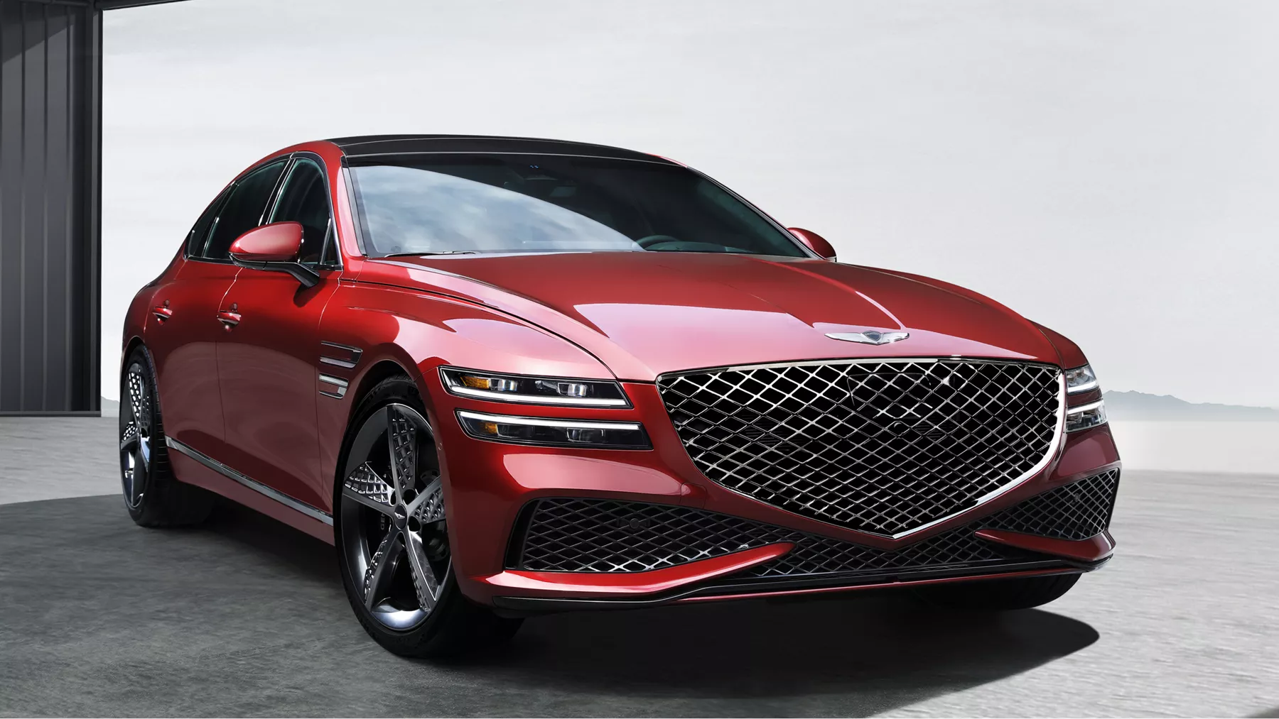 Front view of G80 parked in front of a white wall.