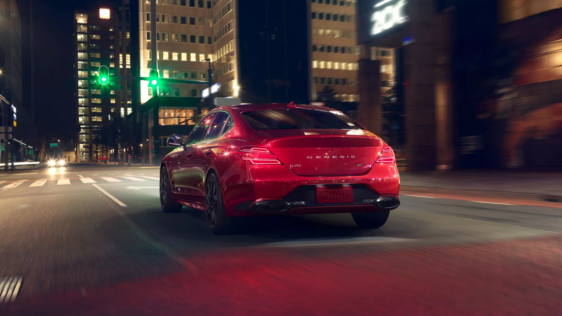 G70 driving through a city at night.