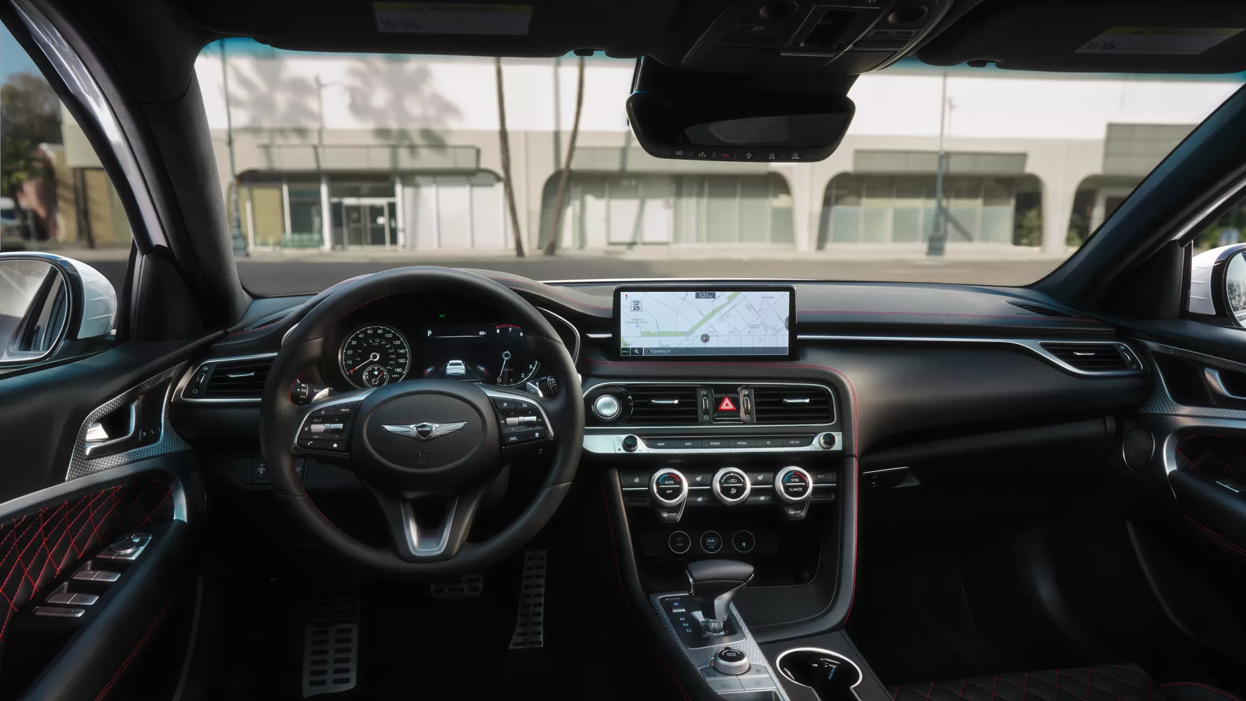 Interior view of G70 steering wheel and front console.