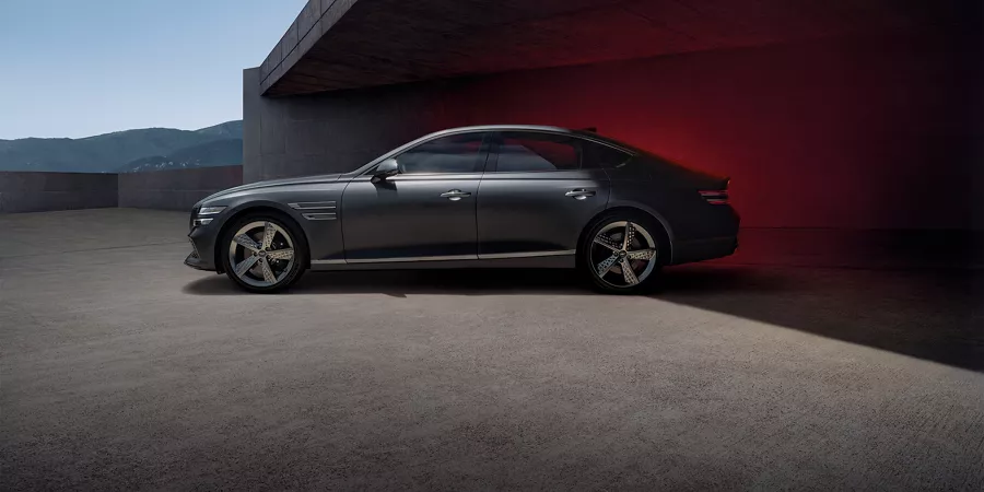 Side profile of G80 parked underneath a cement structure. 