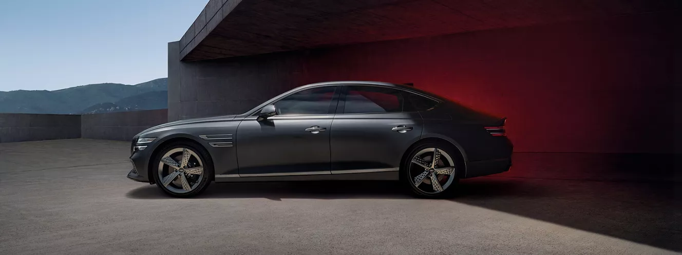 Side profile of G80 parked underneath a cement structure. 