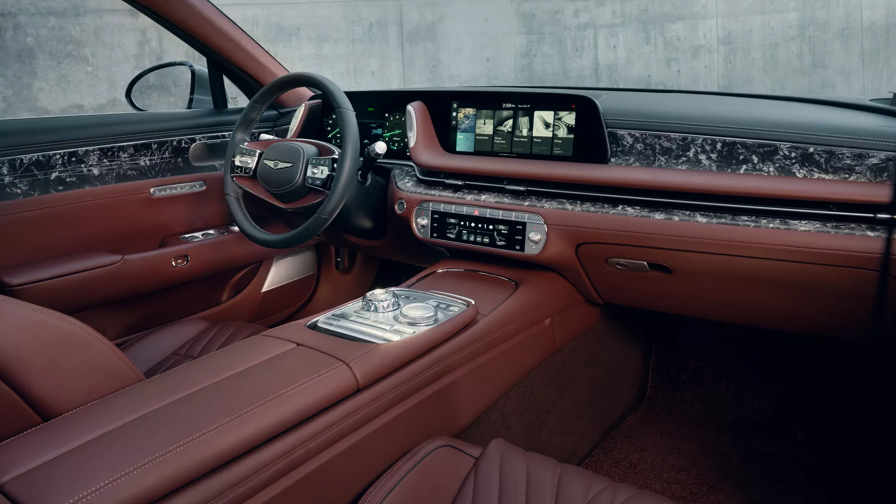 G90 front cabin showing steering wheel and infotainment screen.