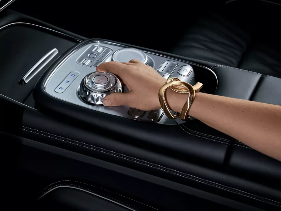 Closeup of 2026 Genesis G90 interior in Black Monotone with hand on center console