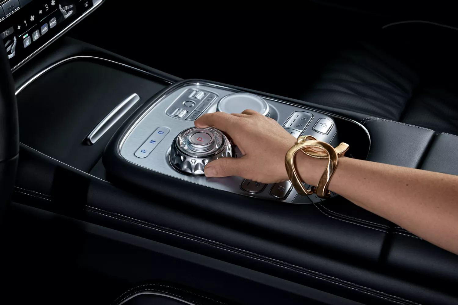 Closeup of 2026 Genesis G90 interior in Black Monotone with hand on center console