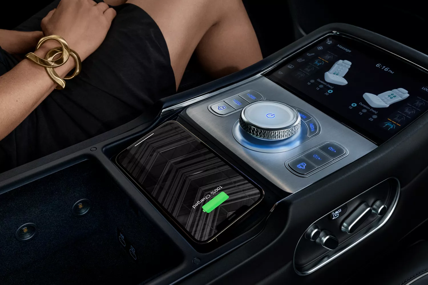 Interior closeup of passenger in black dress next to black center console in 2026 Genesis G90