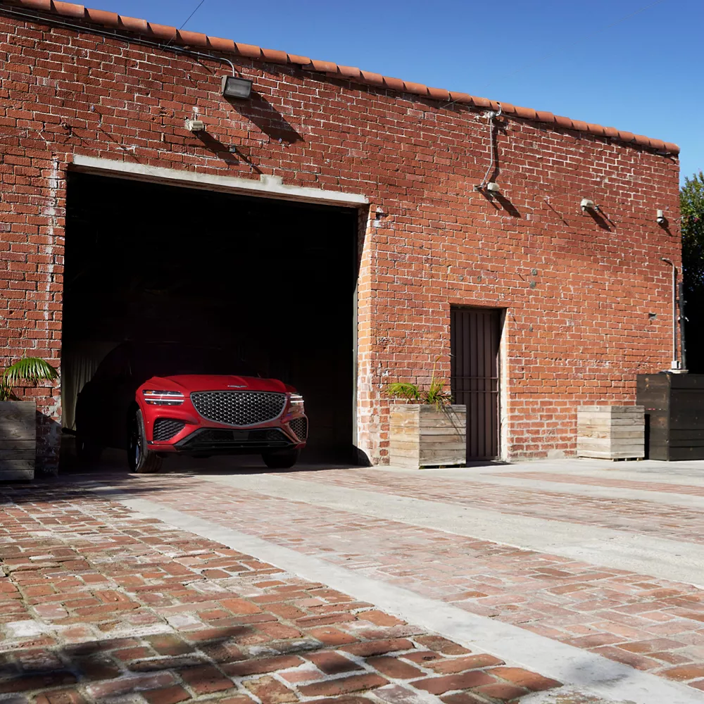 GV70 parked in brick building with only front grille visible.