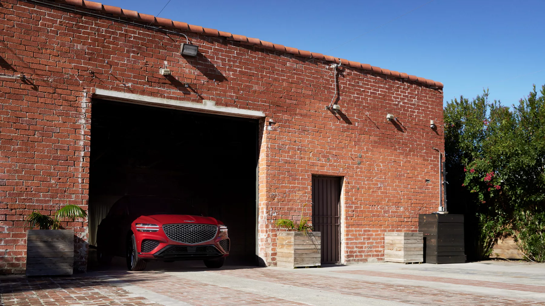 GV70 parked in brick building with only front grille visible.