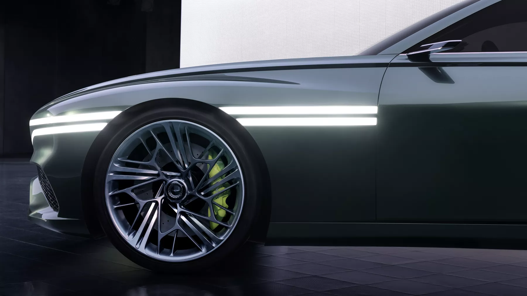 X Speedium Coupe Concept front wheel and illuminated headlight.