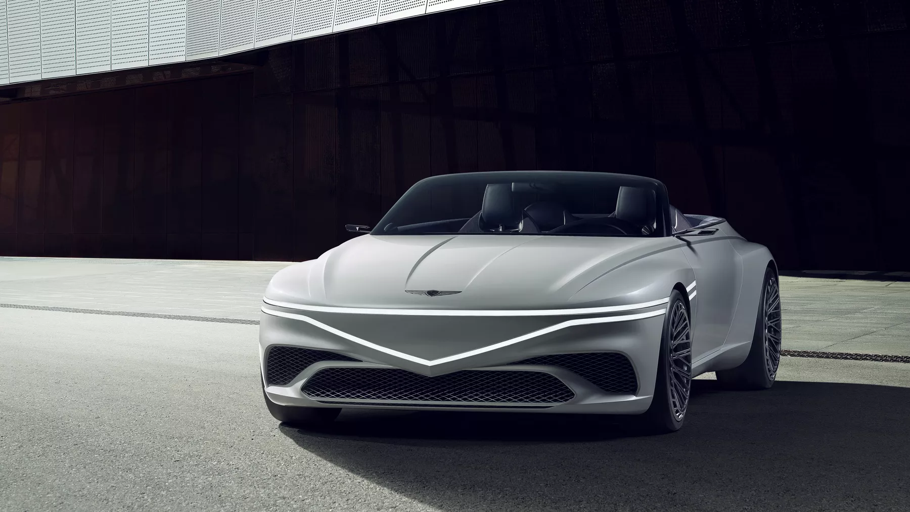 Front view of parked X Convertible Concept with headlights illuminated.