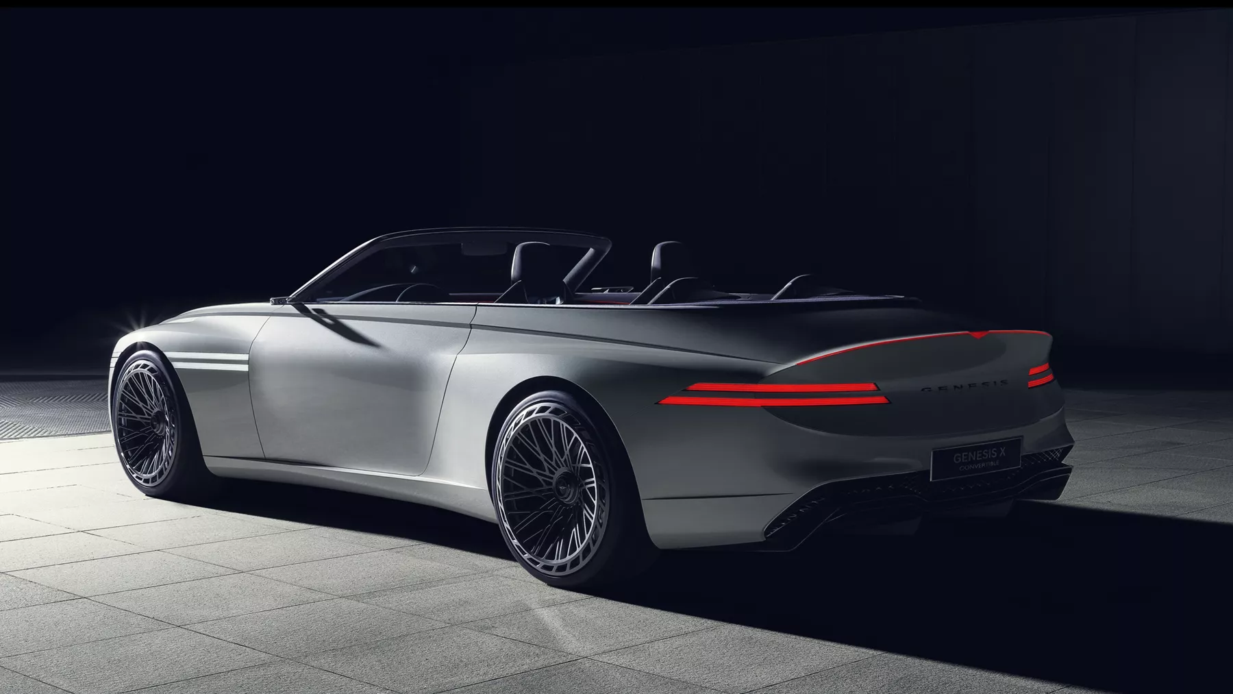 Rear view of X Convertible Concept at night with taillights illuminated.