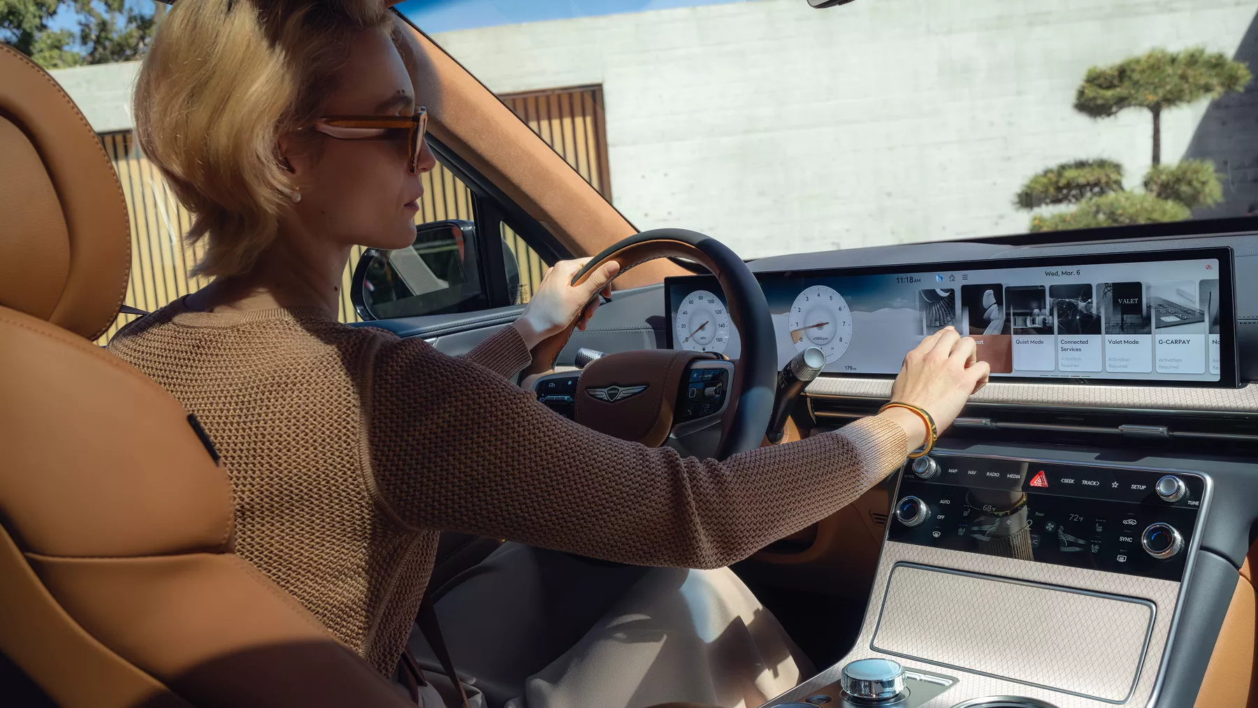 GV80 interior cabin with steering wheel and infotainment screen.