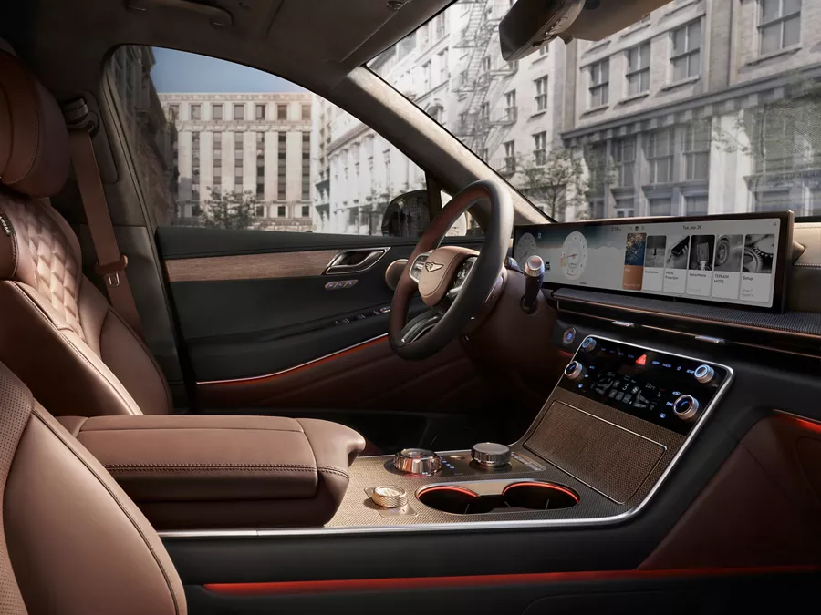 Interior front passenger side pov of Genesis GV80 cabin with brown quilted nappa leather seating