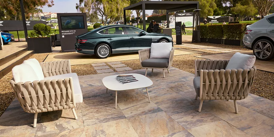 Patio furniture next to a Genesis vehicle