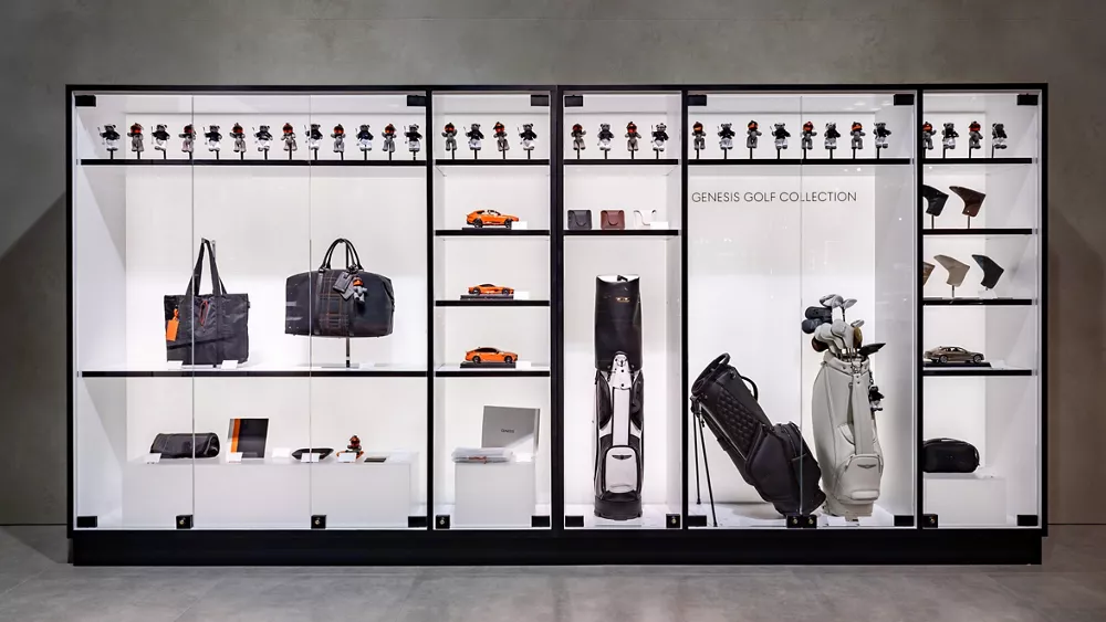 Genesis Golf Collection merchandise display with golf bags, accessories, model cars, figurines, etc.