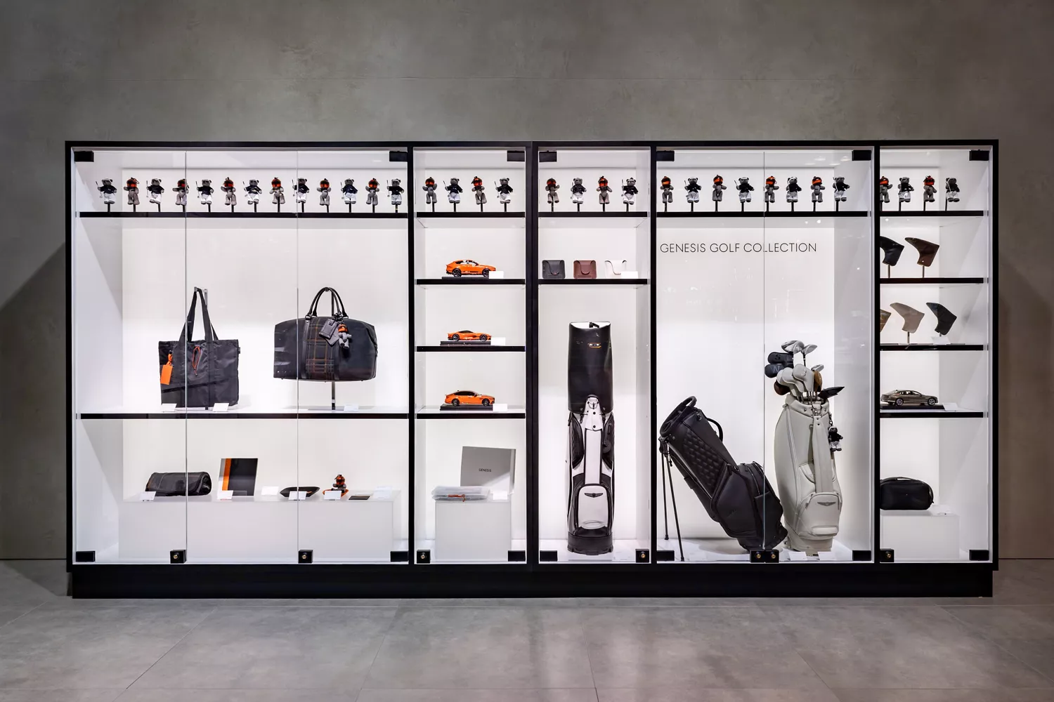 Genesis Golf Collection merchandise display with golf bags, accessories, model cars, figurines, etc.