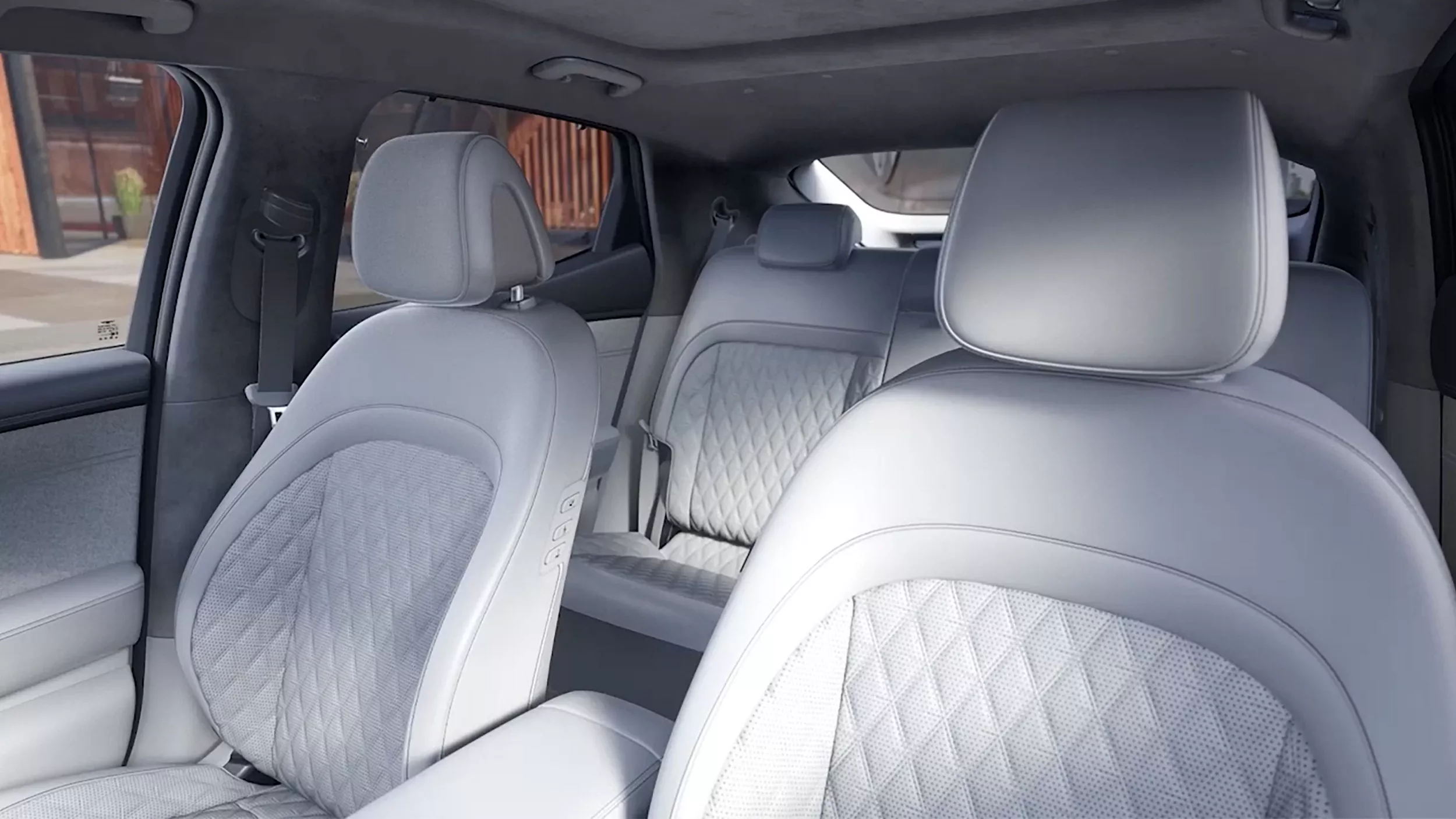 Genesis GV60 rear cabin view from front passenger seat, showing gray nappa leather seats and sunroof