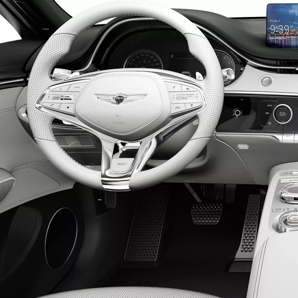 Front cabin of Electrified GV70 with steering wheel and infotainment screen.