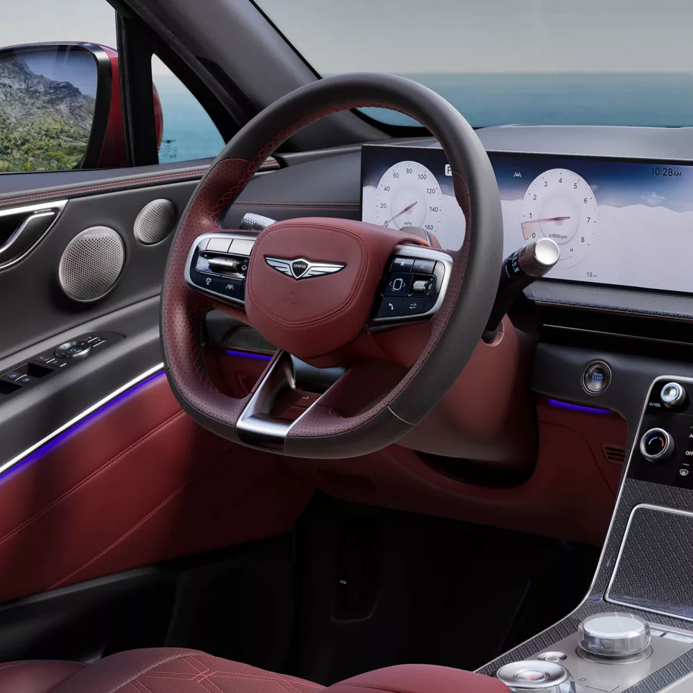 GV80 Coupe interior showcasing the infotainment system and steering wheel design.