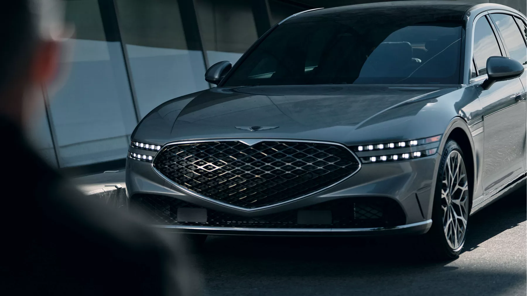 A man in the shadows standing in front of the G90.
