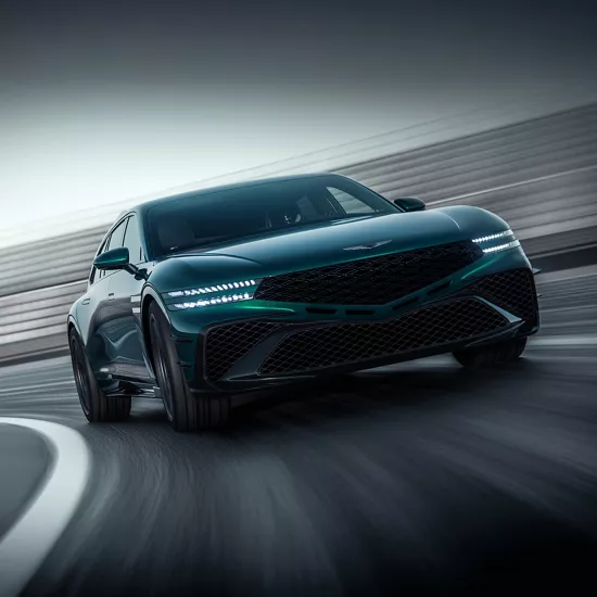 Ground level front 3/4 angle of Genesis G90 Wingback Concept vehicle driving on race track