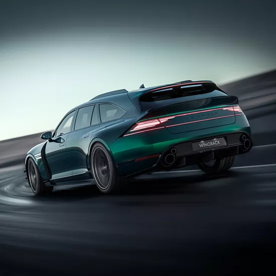 3/4 rear driver side view of Genesis G90 Wingback Concept in green driving on a racetrack