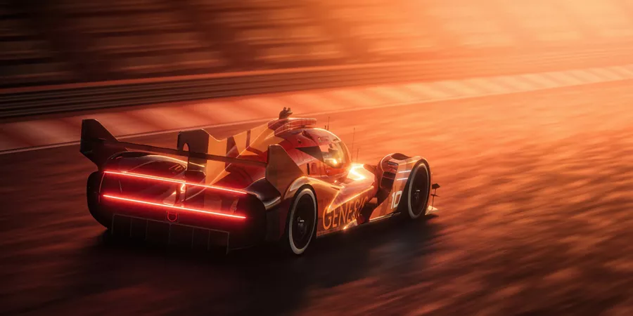 Rear passanger side view of orange Genesis Magma Racing 2025 GMR-001 Hypercar on a race track